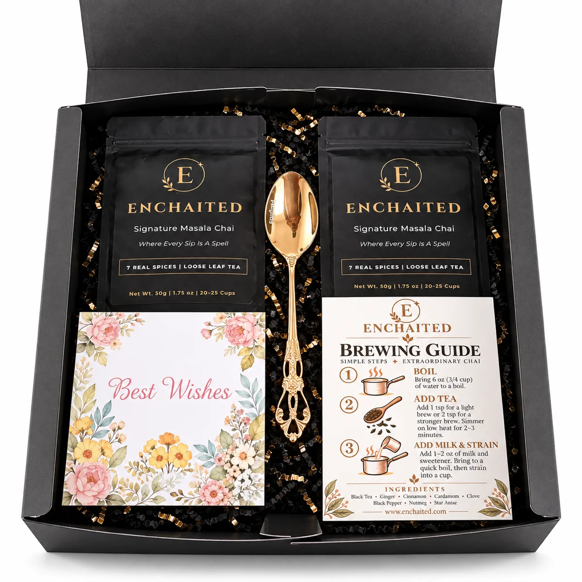 Open Enchaited gift box with two masala chai pouches, a gold teaspoon, a Best Wishes card and a brewing guide