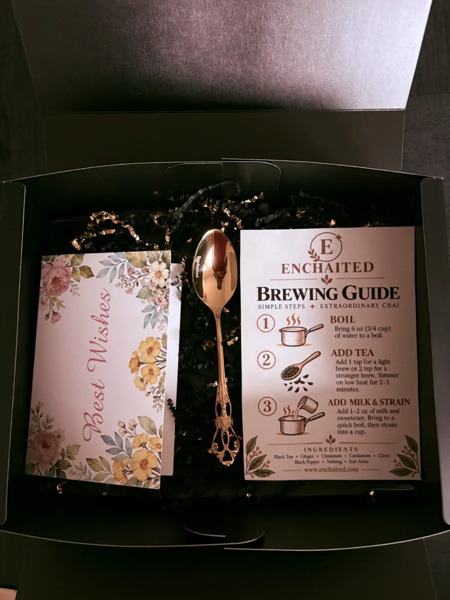The Enchaited gift box opened on a table, with pouches, cards and the gold teaspoon