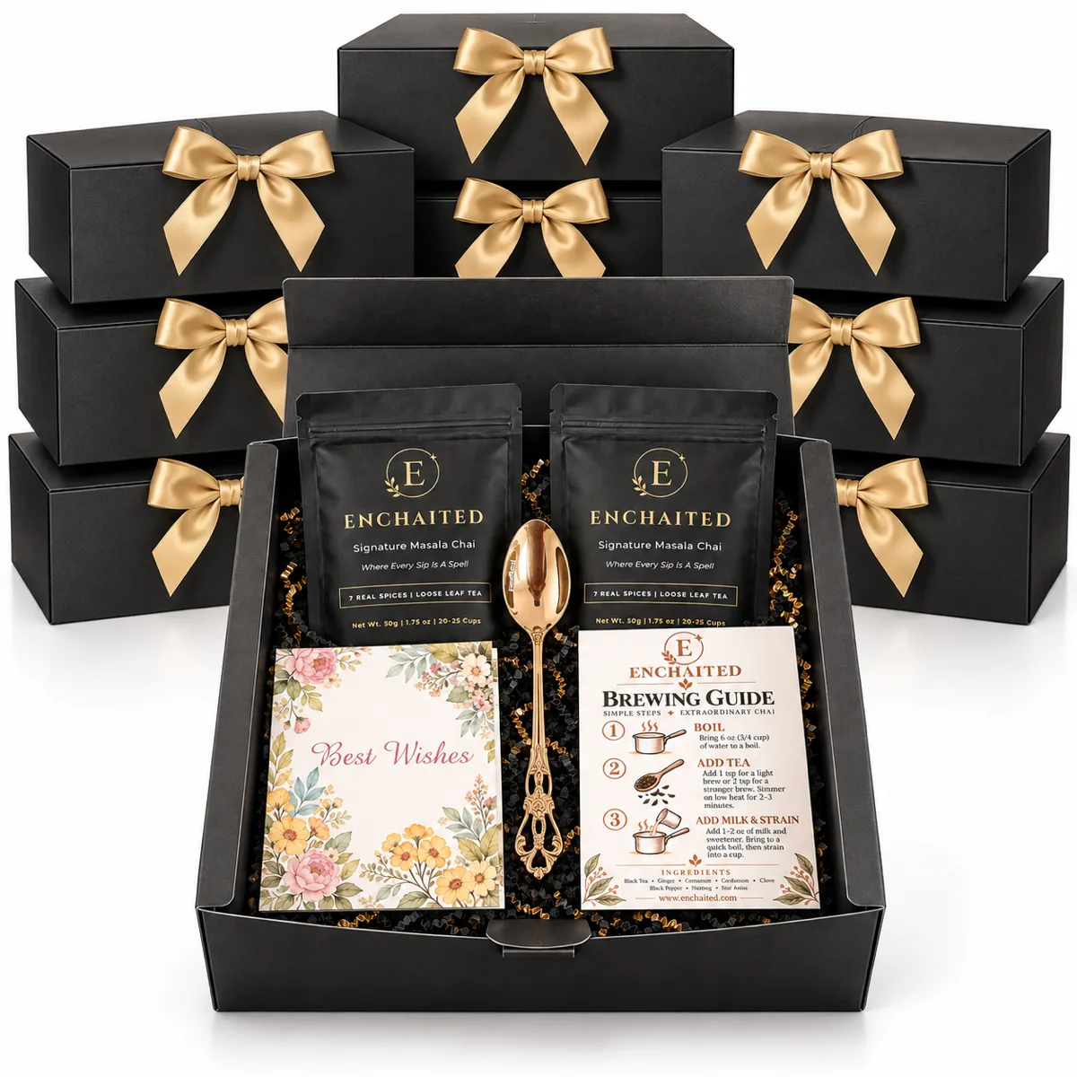 A stack of Enchaited gift boxes with gold ribbons behind an open box